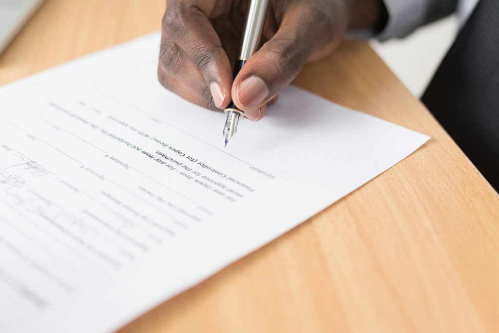 african lawyer signing a document signifying the whistleblower protection act kenya